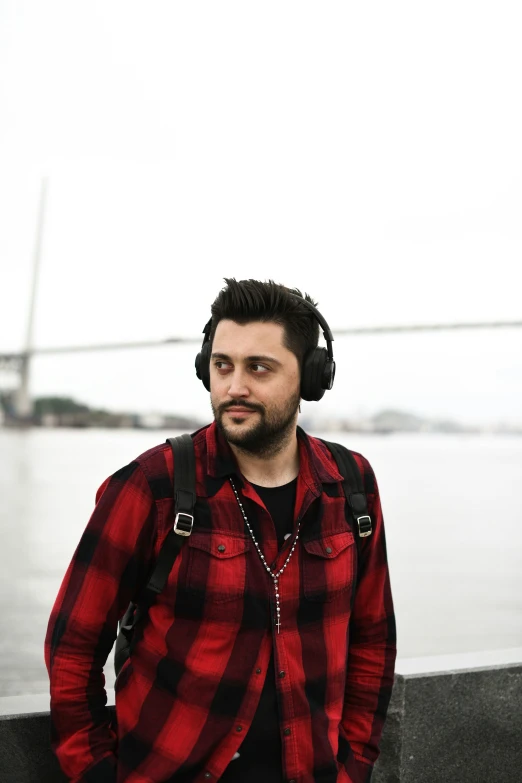 a man with headphones on is looking at the camera
