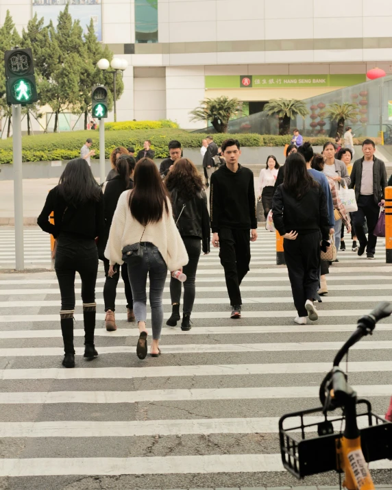 a group of people crossing an intersection at an airport