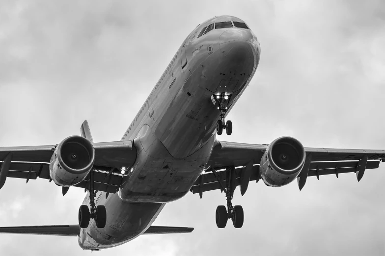 black and white po of an airplane flying in the sky