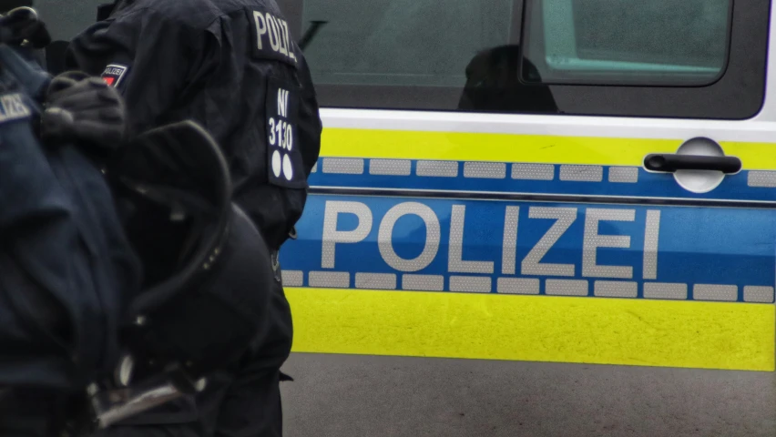 two policemen with their bags on the street