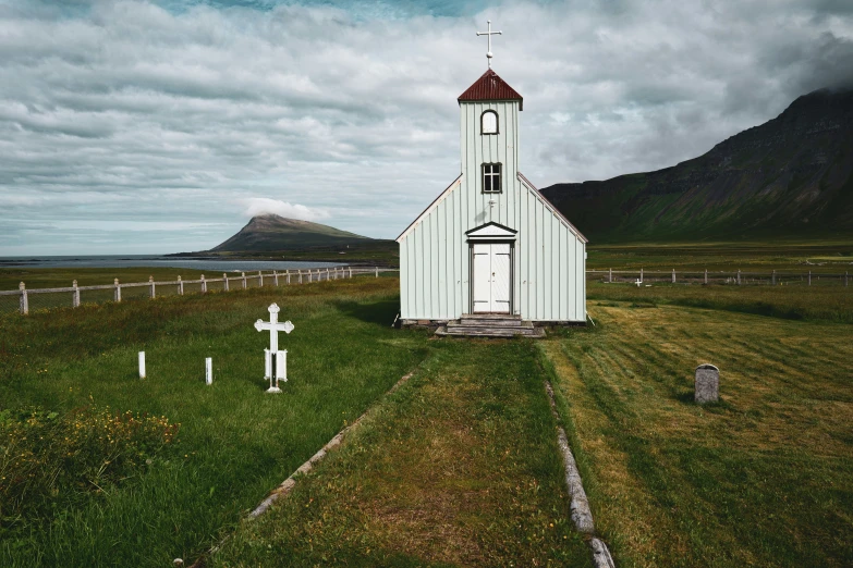 the small church is in the middle of an empty field