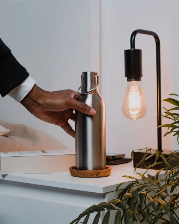 a person lighting a light bulb in a room