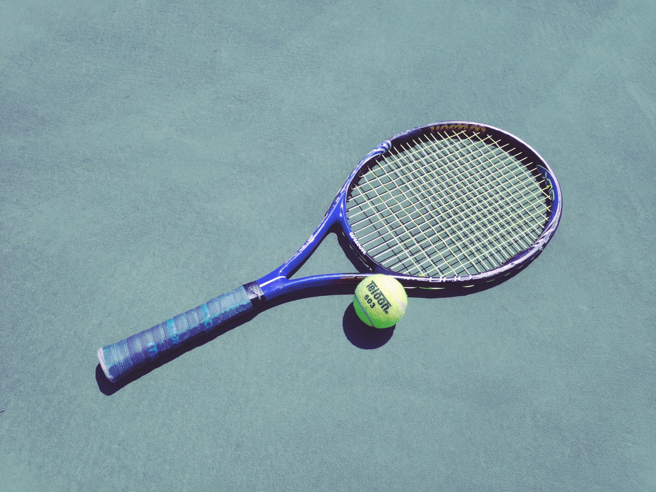 an aerial po of a tennis racket and ball