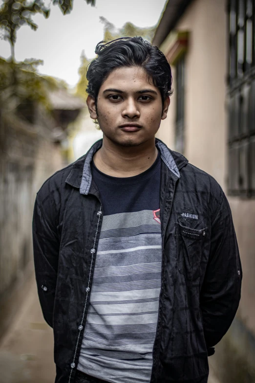 a young man in a jacket looking away from the camera