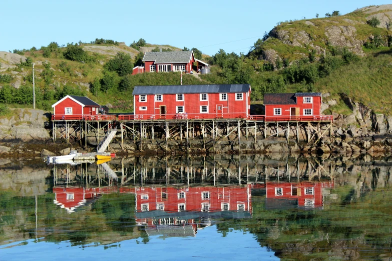 a small boat sits docked at a fishing dock