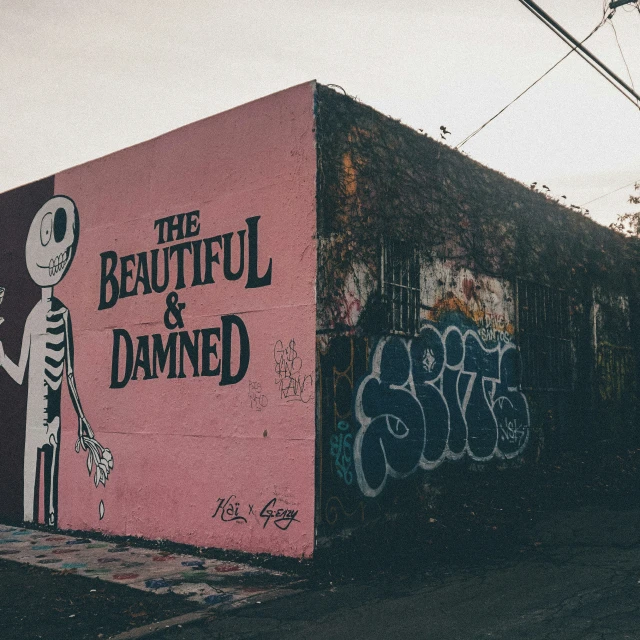 a pink building has graffiti on the side