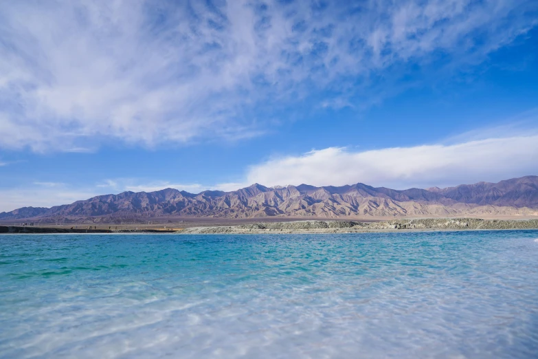 a body of water with a large mountain in the background