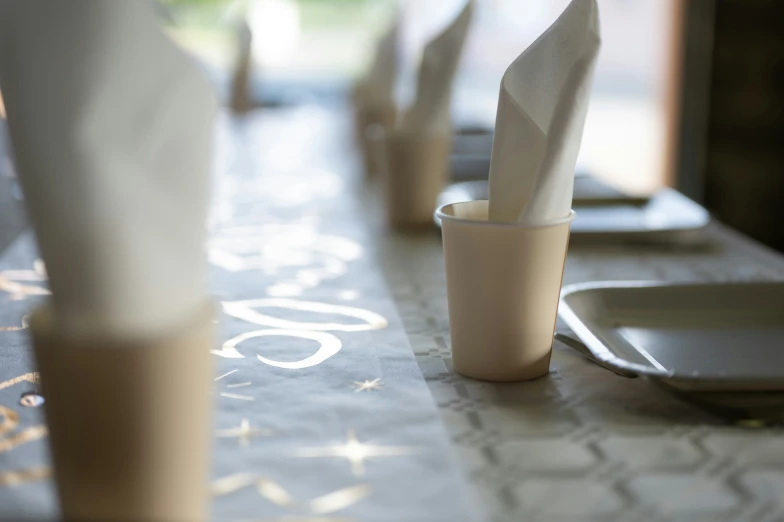 several empty cups are placed along a table