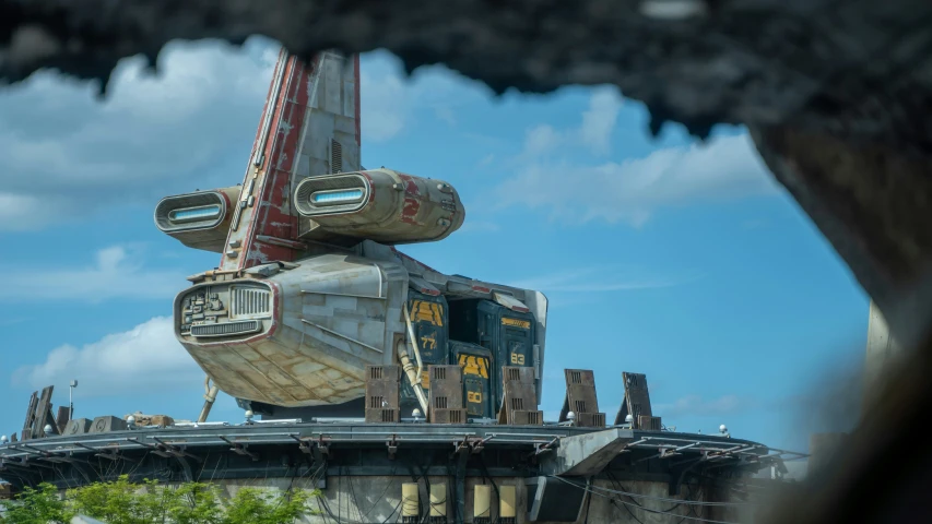 a star wars vehicle sitting atop a building next to a bridge