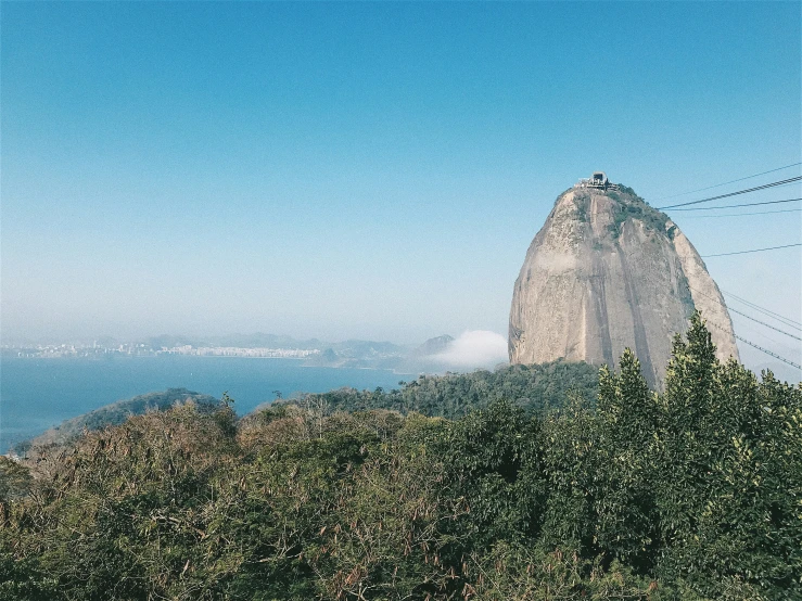 a very tall mountain with some green plants