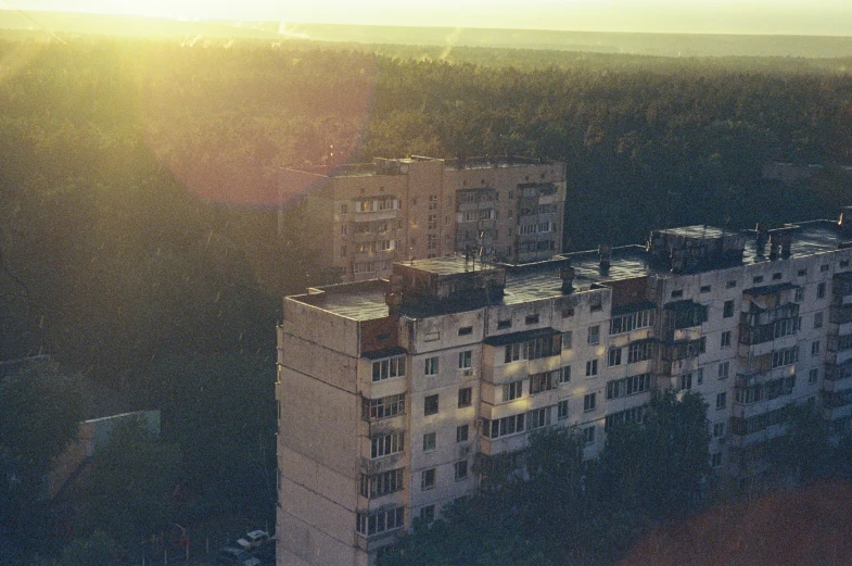 the sun is shining behind an apartment building