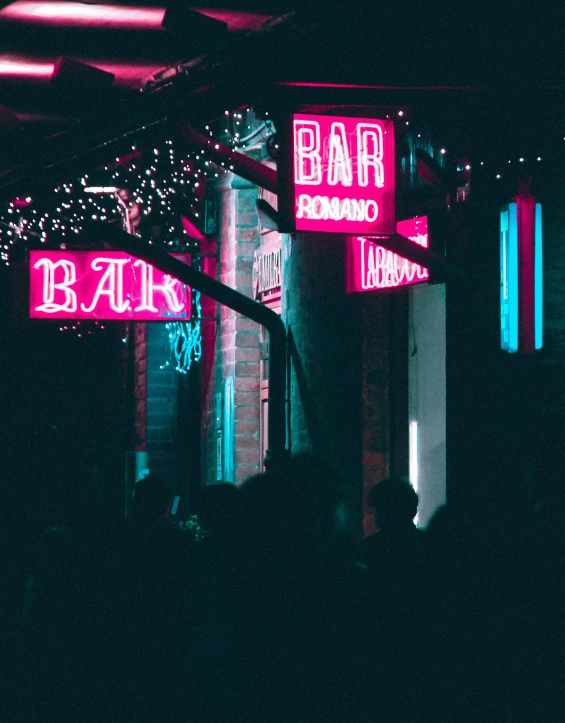 some neon signs and buildings in a city