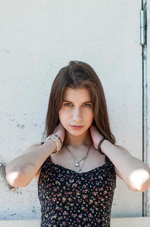 young woman covering her ears with hands while posing for a po