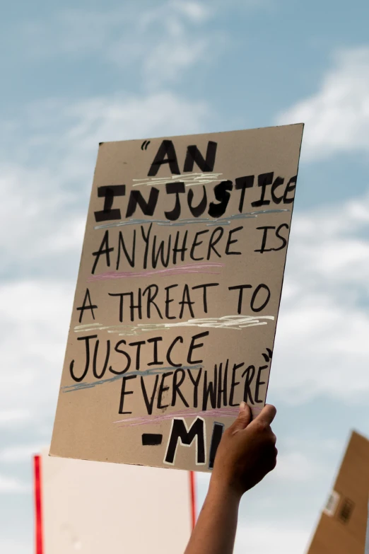 someone holding up a sign reading an in - article where is a threat to justice everywhere
