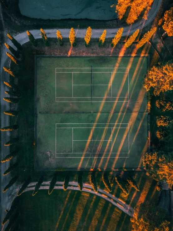 an aerial view of the tennis court in autumn