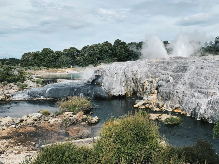 steam rising from the ground at the end of a river