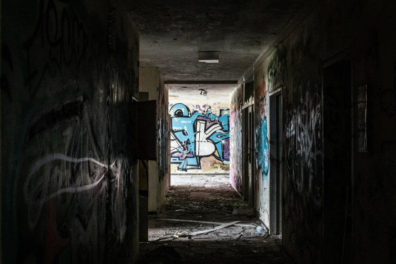 a tunnel is shown with graffiti on the walls