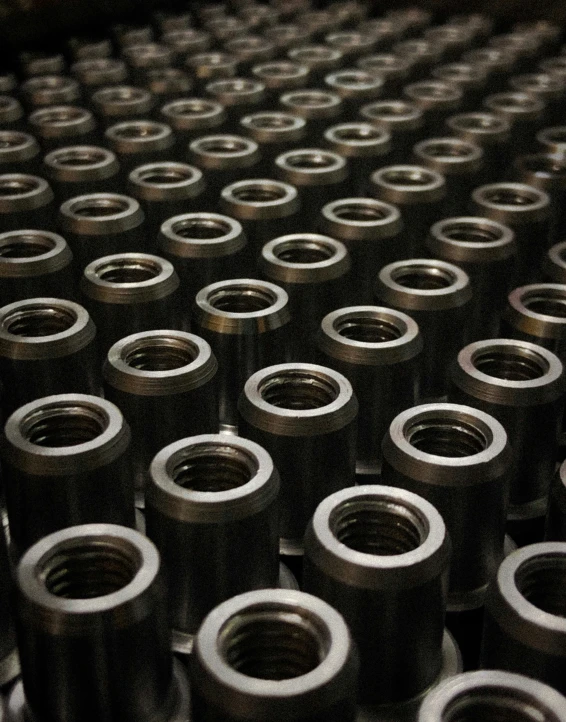 an array of metal nuts and washers arranged into a background