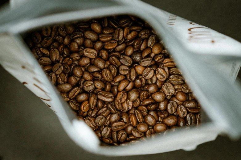 a small white bag filled with coffee beans