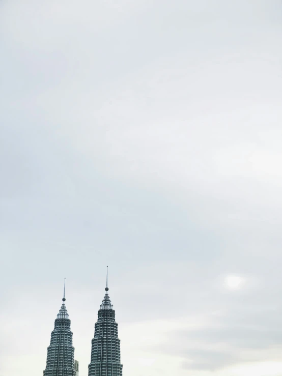 three very tall buildings with some very large spires