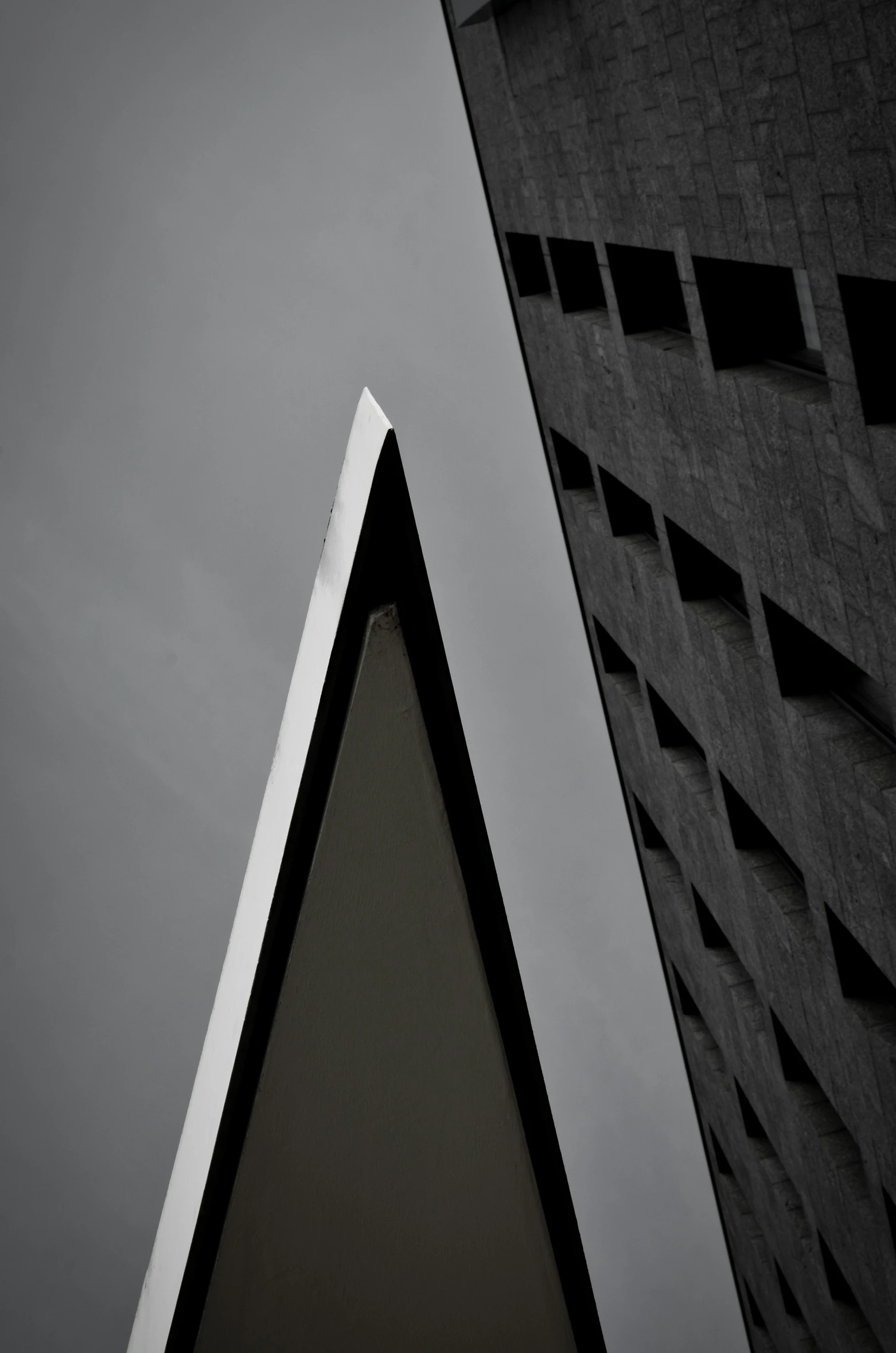 a triangular building is seen with a clock