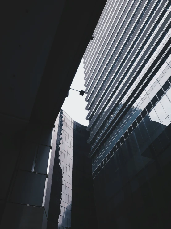 looking up at the tops of several tall buildings