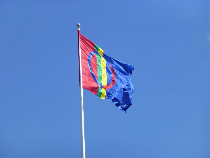 a flag flying high on a clear day