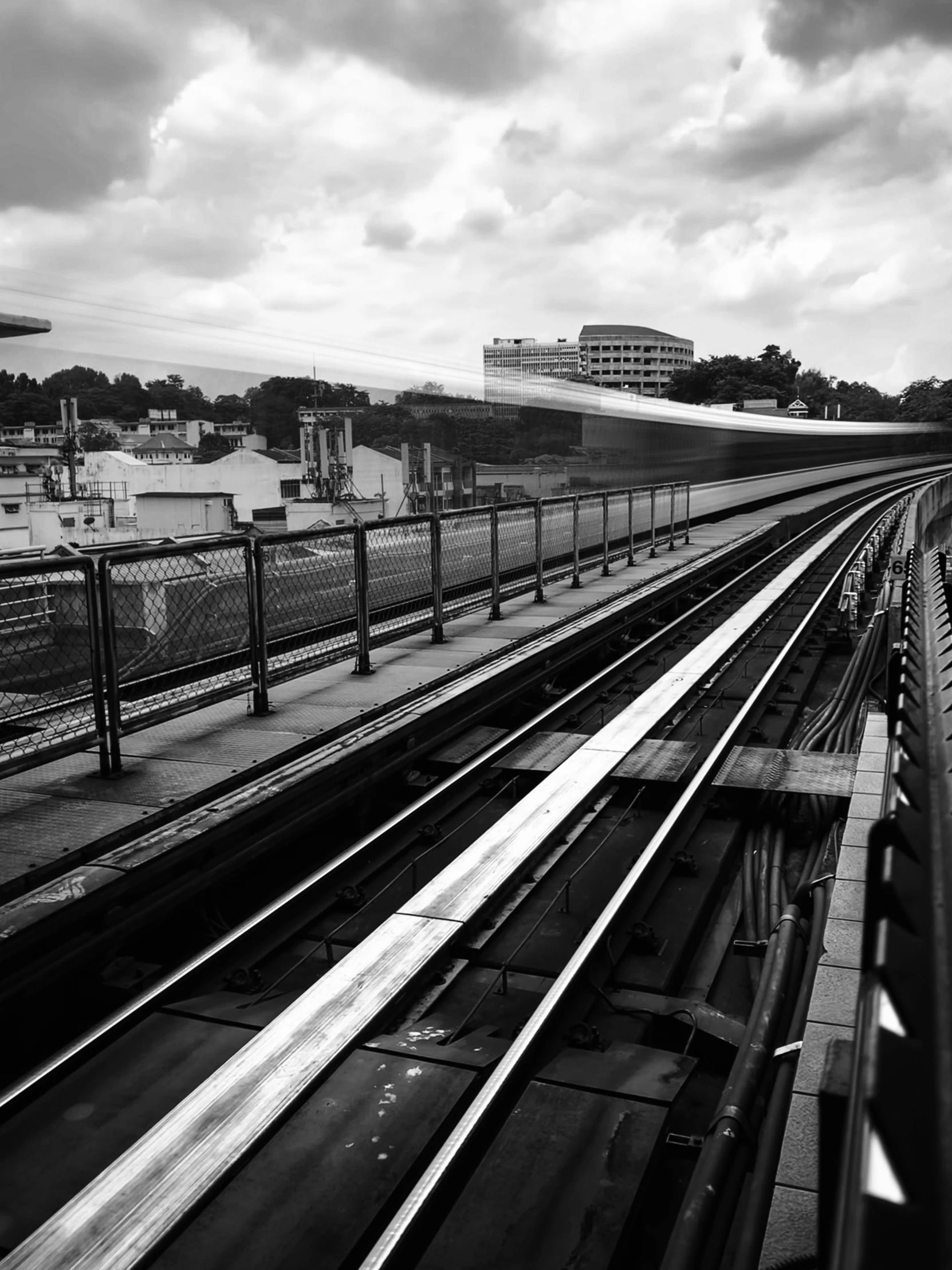 a set of railroad tracks on an overcast day