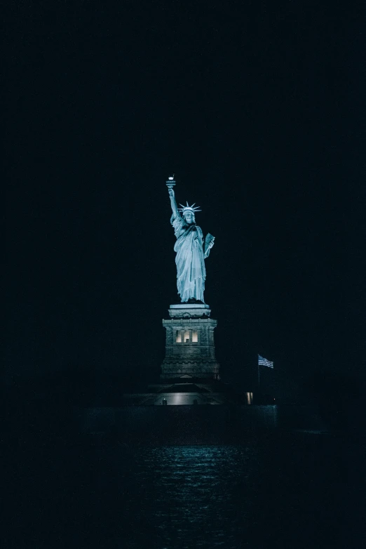 an image of the statue of liberty taken at night