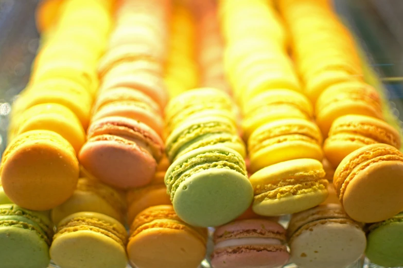 a bunch of various colored cookies are in a pile