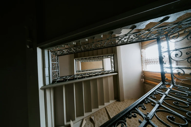 view of ornate metal railing and stairway at night