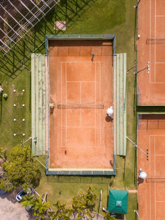 a tennis court with grass and dirt flooring