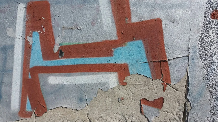graffiti on a building wall depicting two interlocked lines