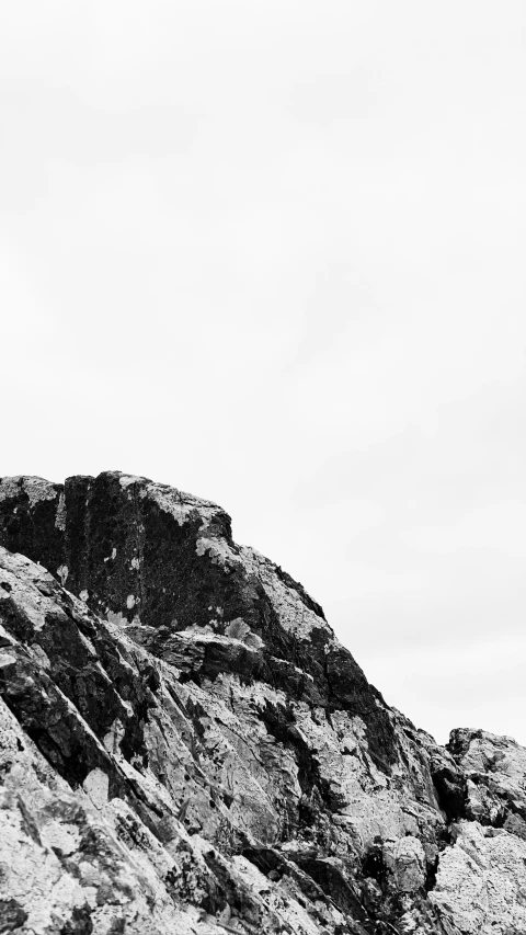 silhouette of man climbing up a steep hill