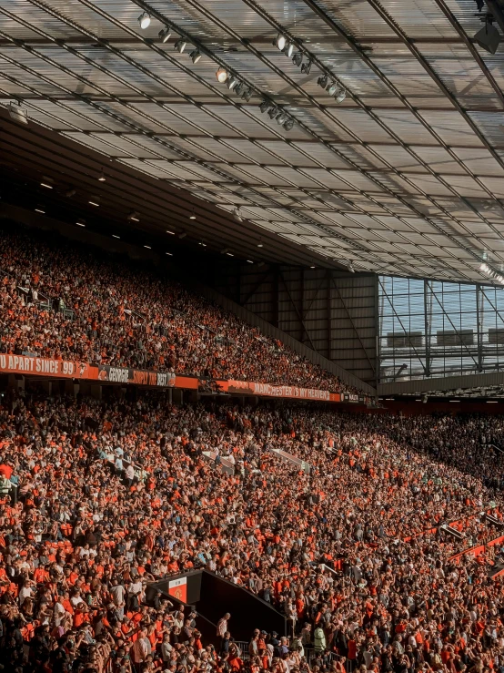 an arena filled with lots of people sitting and watching