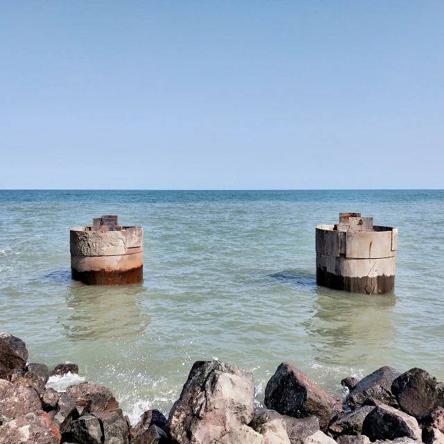 two concrete boxes sitting on the beach