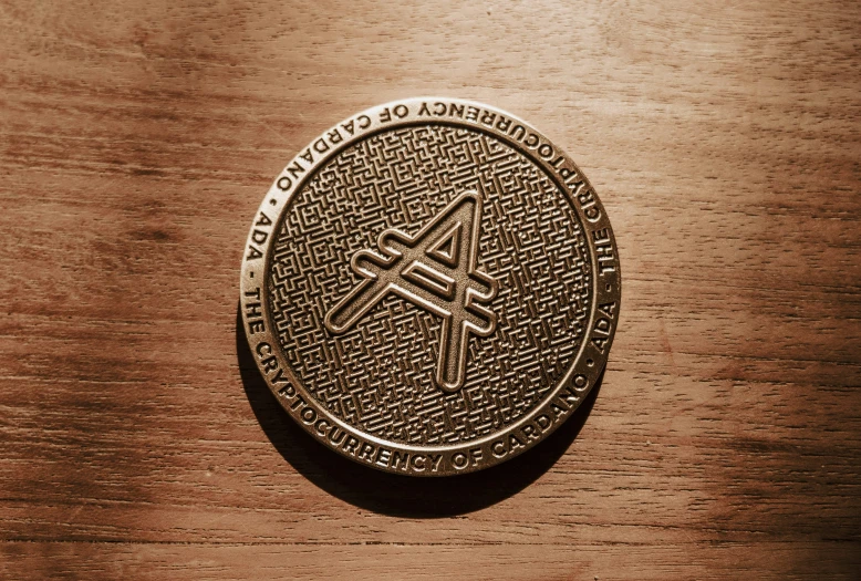 a bronze round with a sign of anarchy on it