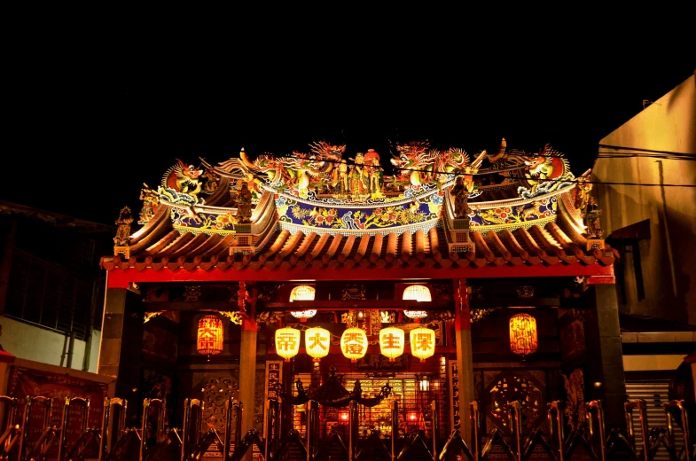 an oriental style building lit up at night