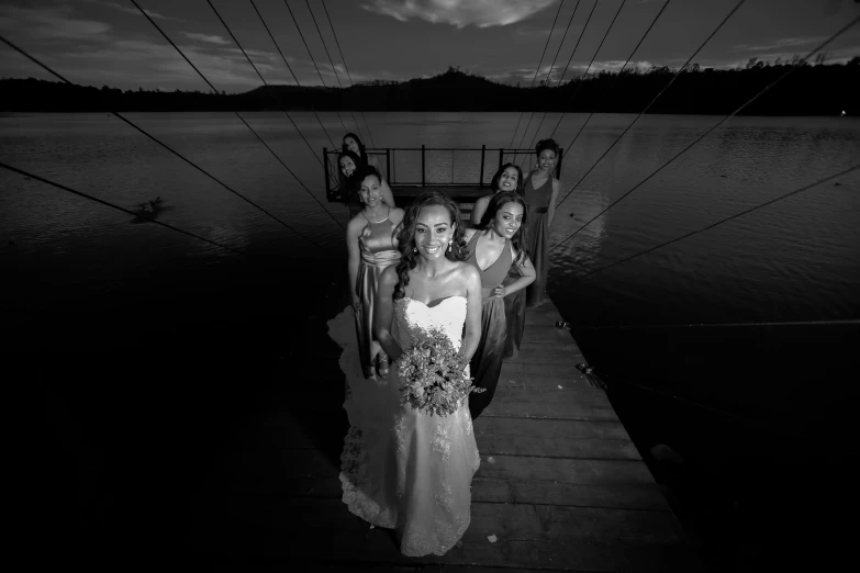 bride and her bridesmaids pose for pos before going in to the water