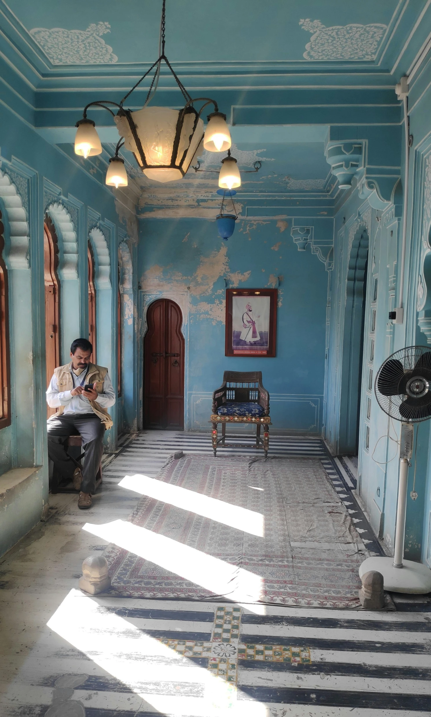 a man with a baby in his arms in an old run down building