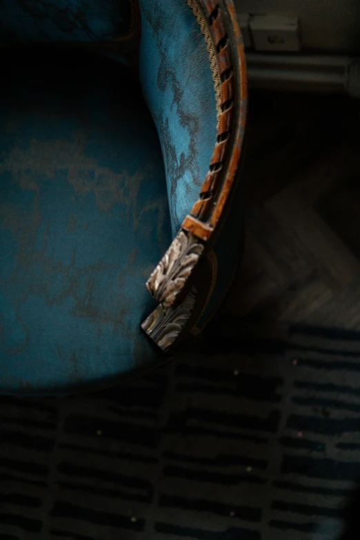 an old wooden arm rest on a blue chair