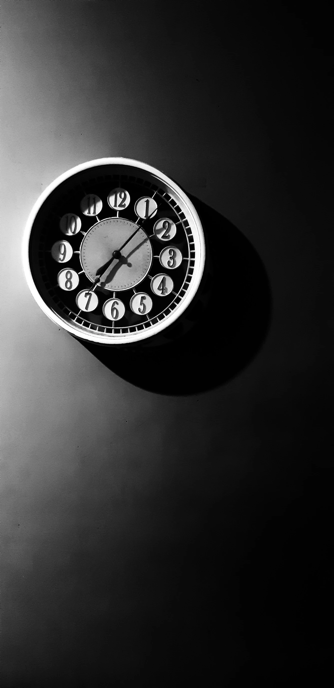 a clock with different faces on a black surface