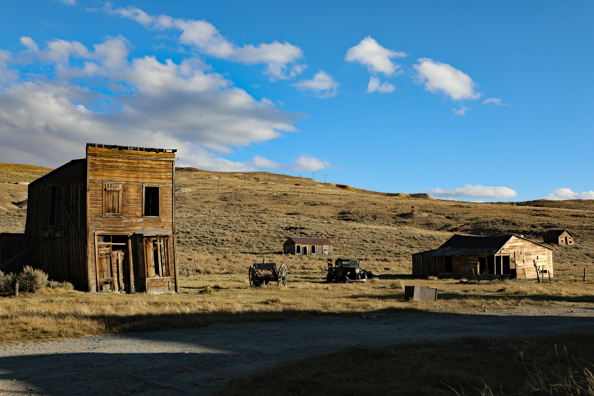 an old dilapidated building stands in a dry field