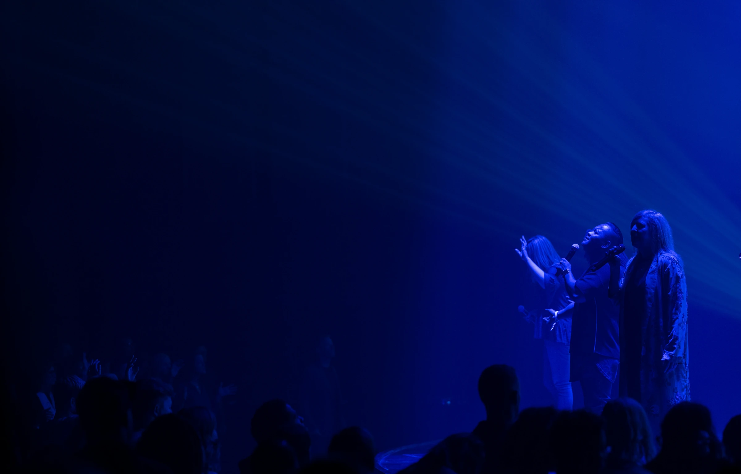 two people singing on stage at a concert