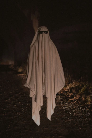 a ghostly figure dressed in a cloth with eyes