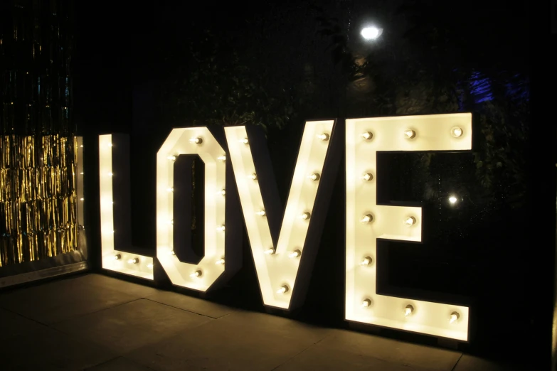 lighted letters spelling love in an illuminated entry way