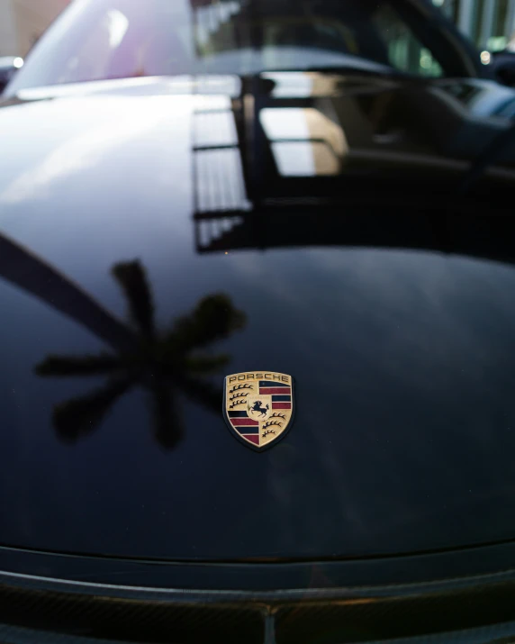 a porsche emblem on the hood of a car