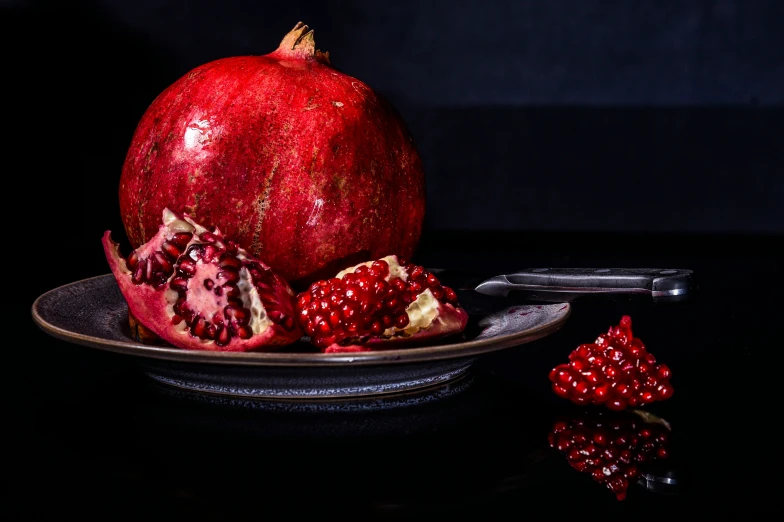 a large pomegranate sitting on top of a black table