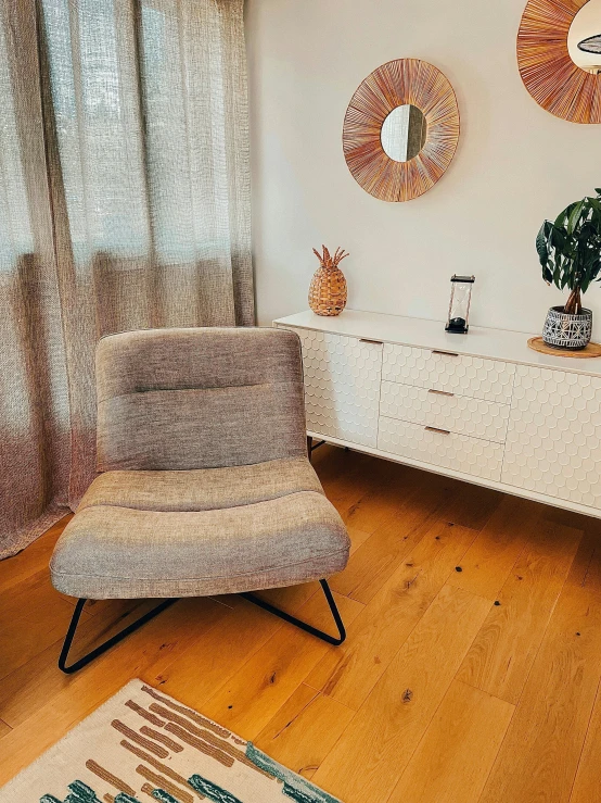 an orange and white chair sitting next to a white dresser