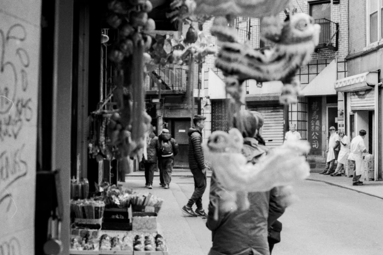 people walking down an urban street in the day